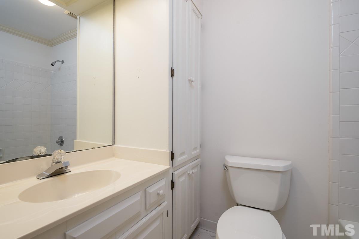 3302 Ridgecrest Court Raleigh, NC 27607 - Photo 16 of 23 a bathroom with a toilet sink and mirror