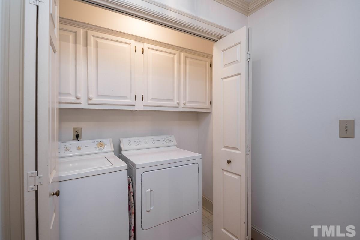 3302 Ridgecrest Court Raleigh, NC 27607 - Photo 17 of 23 a view of cabinets with washer and dryer