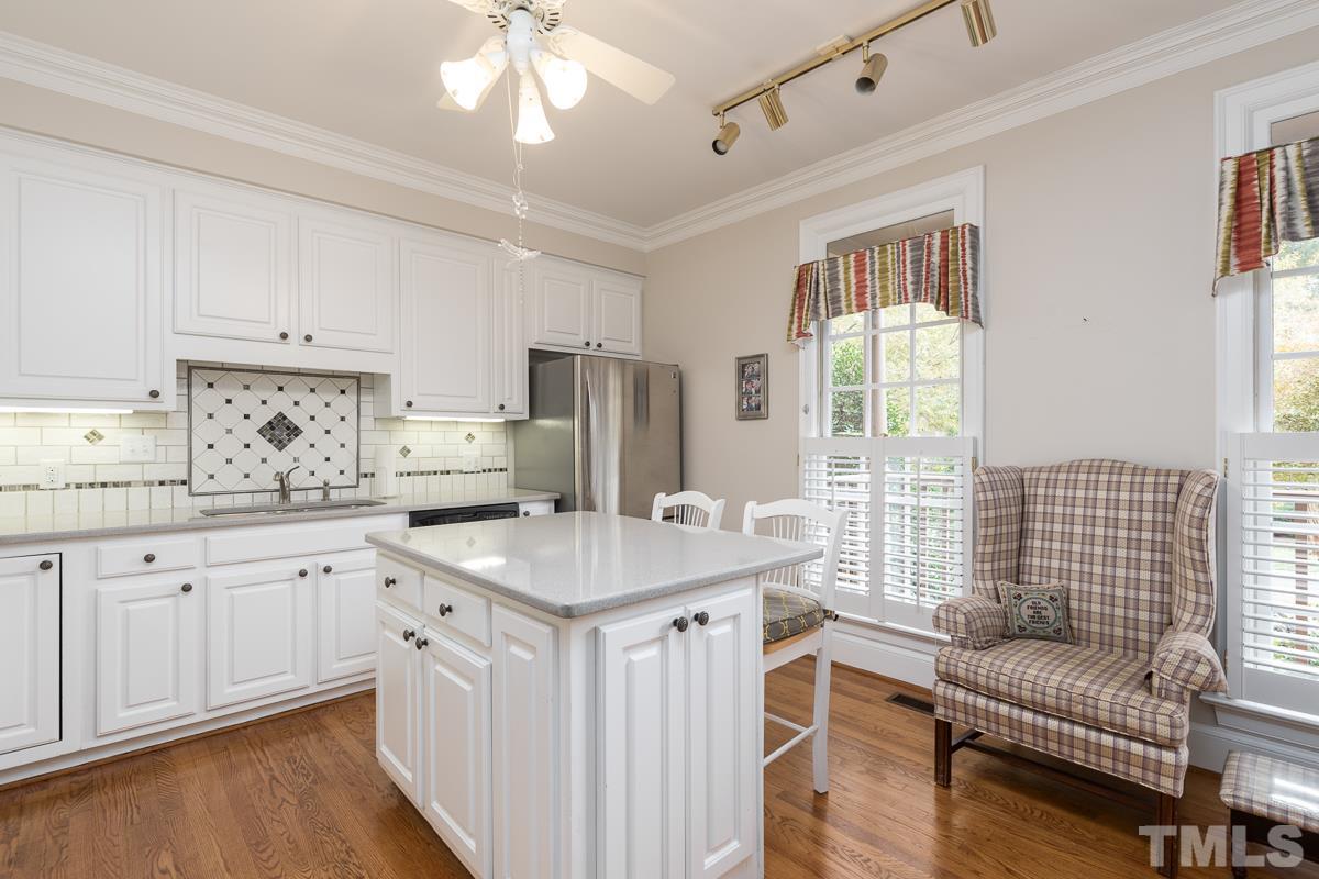 3302 Ridgecrest Court Raleigh, NC 27607 - Photo 3 of 23 a kitchen with stainless steel appliances granite countertop a sink stove and wooden cabinets