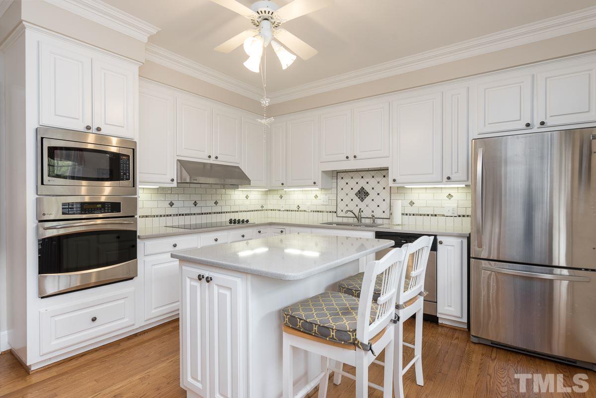 3302 Ridgecrest Court Raleigh, NC 27607 - Photo 4 of 23 a kitchen with stainless steel appliances a stove a sink and a refrigerator