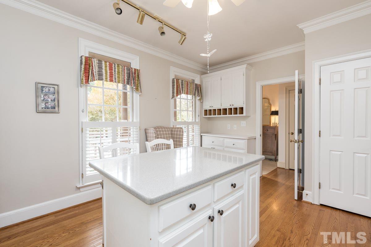 3302 Ridgecrest Court Raleigh, NC 27607 - Photo 5 of 23 a view of kitchen with center island wooden floor and window