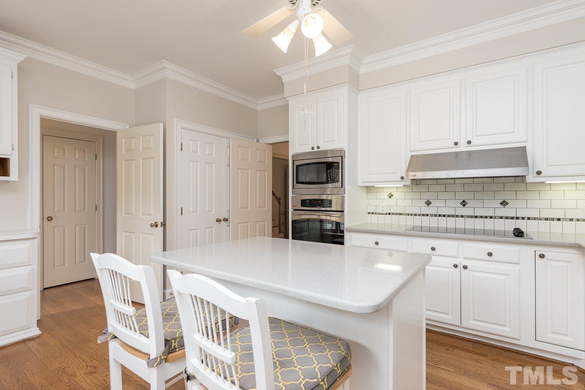 3302 Ridgecrest Court Raleigh, NC 27607 - Photo 6 of 23 a kitchen with a stove a refrigerator and a sink with cabinets