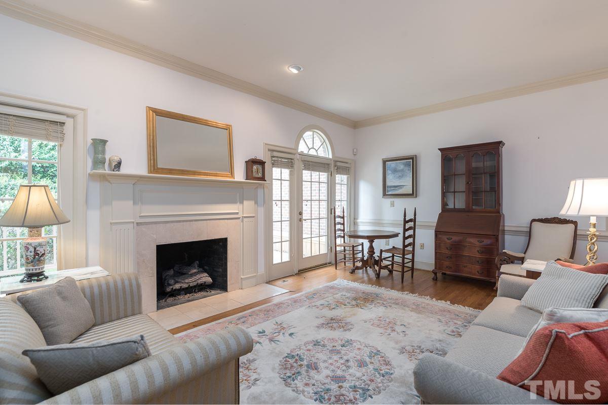 3302 Ridgecrest Court Raleigh, NC 27607 - Photo 9 of 23 a living room with furniture and a fireplace