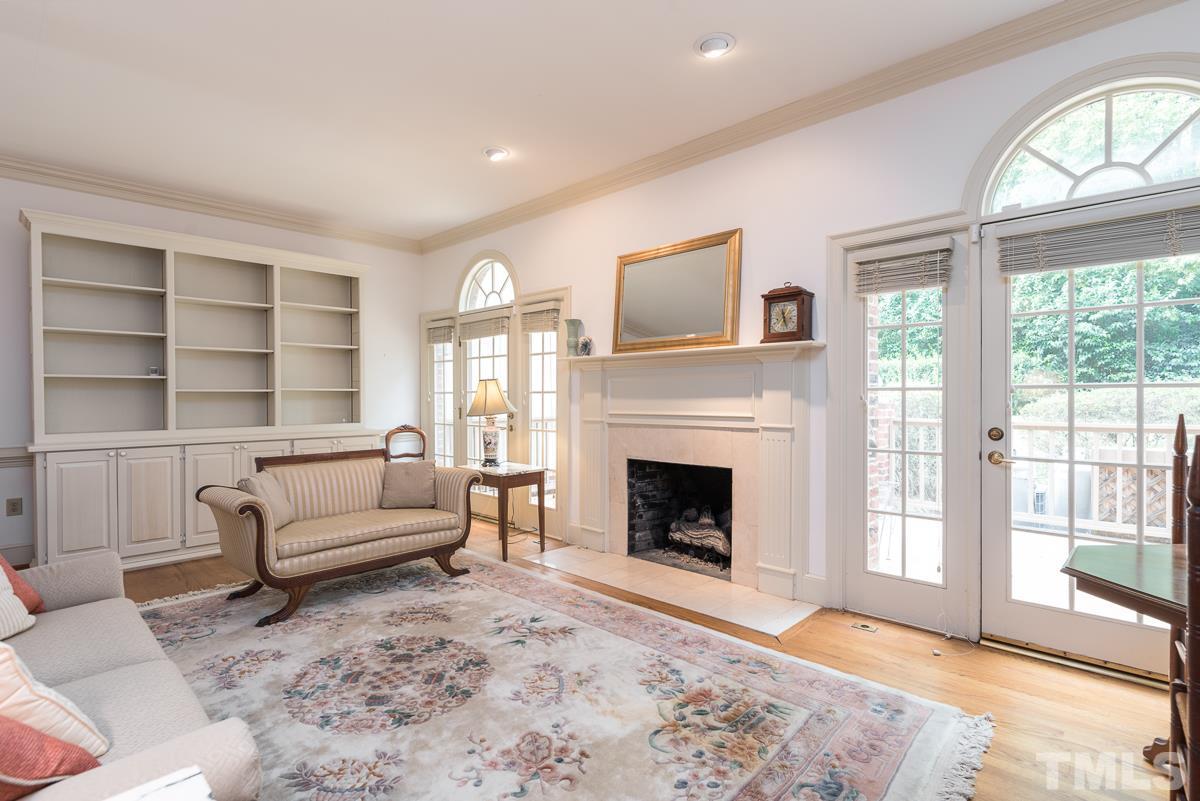 3302 Ridgecrest Court Raleigh, NC 27607 - Photo 10 of 23 a living room with furniture and a fireplace