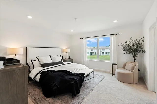 a spacious bedroom with a bed and a couch