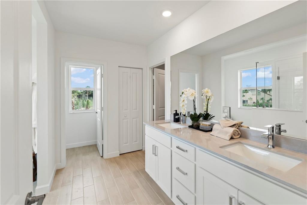 22036 Brookmont Drive Boca Raton, FL 33433 - Photo 14 of 32 a bathroom with a double vanity sink and a mirror
