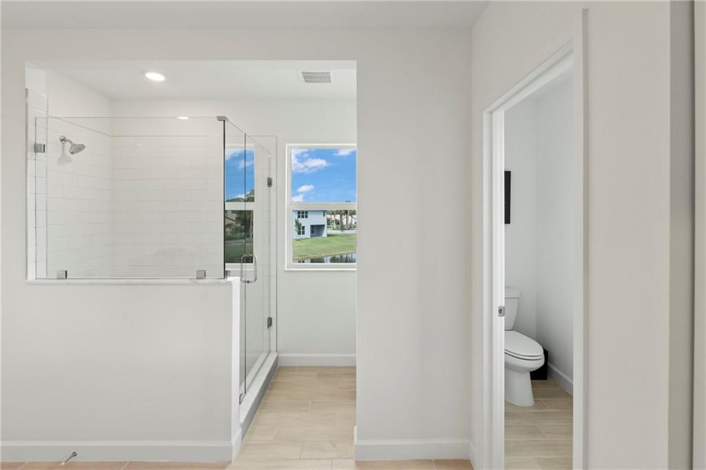 22036 Brookmont Drive Boca Raton, FL 33433 - Photo 15 of 32 a bathroom with a shower and a toilet