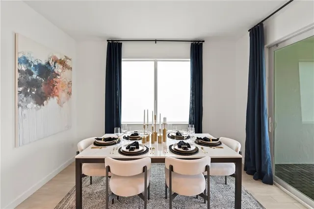 a view of a dining room with furniture and window