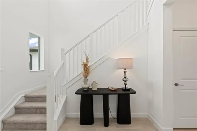 a view of entryway and hall with wooden floor