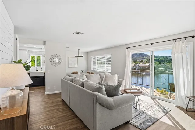 a living room with furniture a flat screen tv and a potted plant