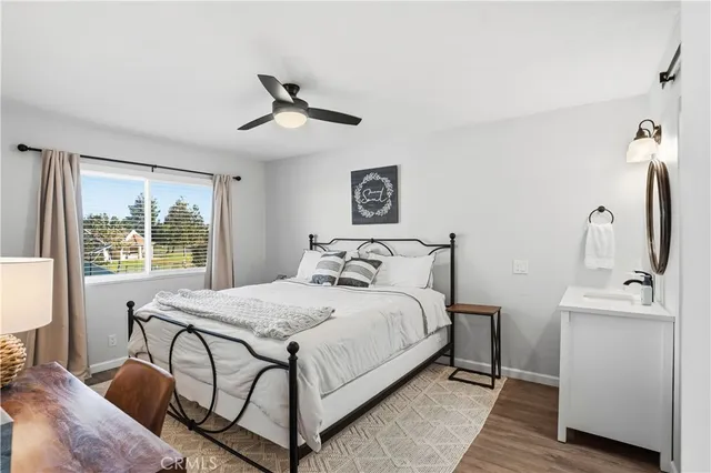 a view of a room with wooden floor and white walls
