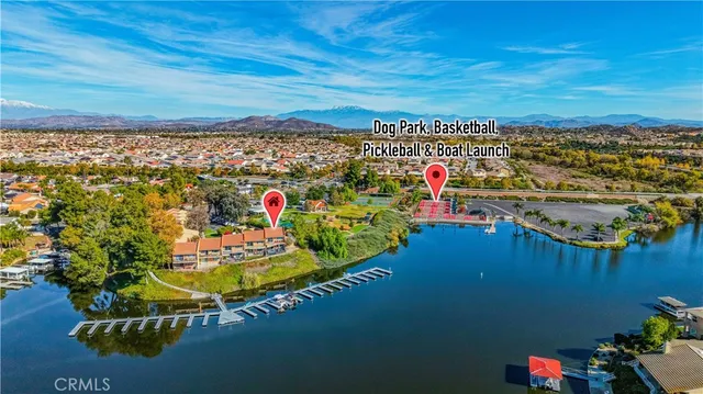 an aerial view of residential houses with outdoor space and ocean view