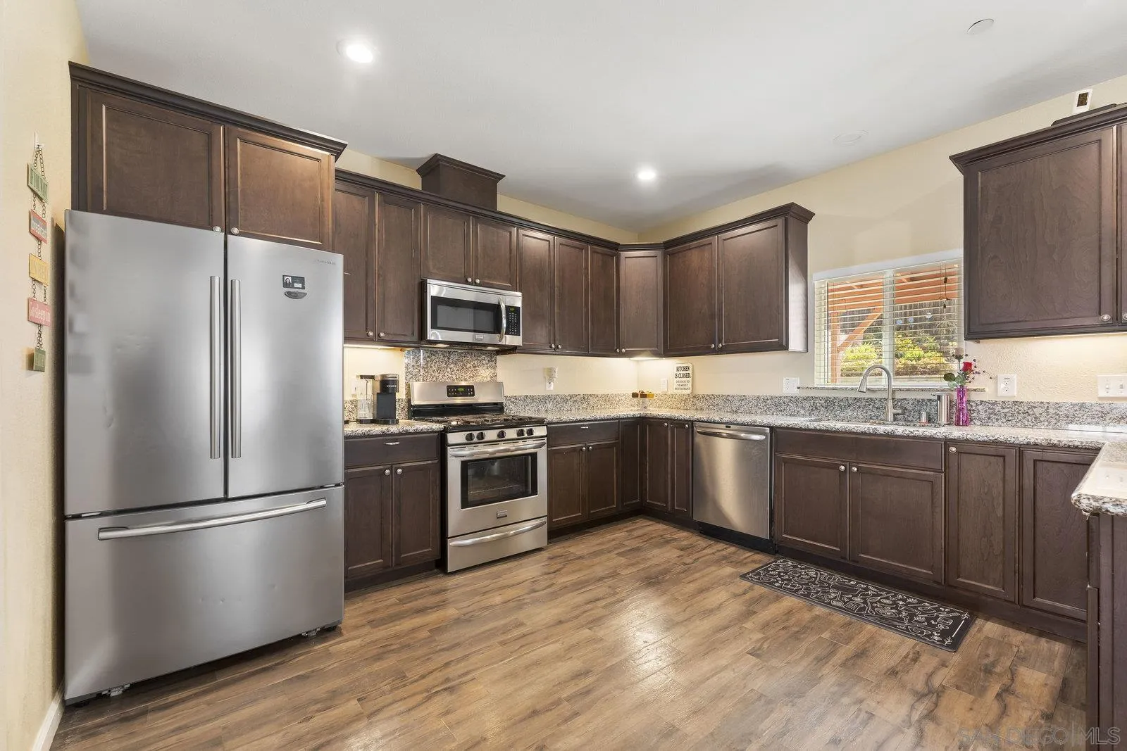 1637 Paraiso Avenue Spring Valley, CA 91977 - Photo 2 of 45 a kitchen with granite countertop stainless steel appliances a refrigerator sink and microwave