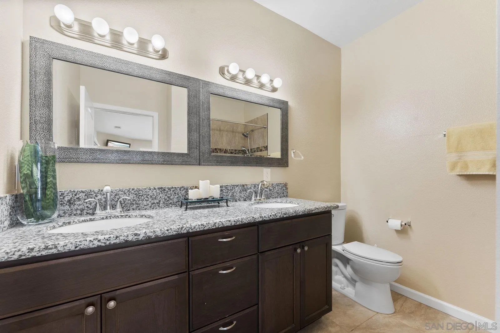 1637 Paraiso Avenue Spring Valley, CA 91977 - Photo 32 of 45 a bathroom with a granite countertop sink a toilet and a mirror