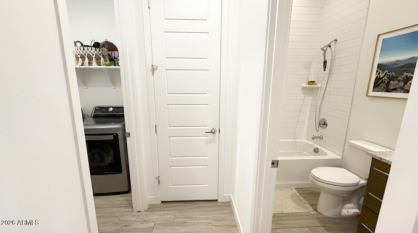 19615 West Cheery Lynn Road Buckeye, AZ 85396 - Photo 17 of 32 guest hall bath and laundry hallway