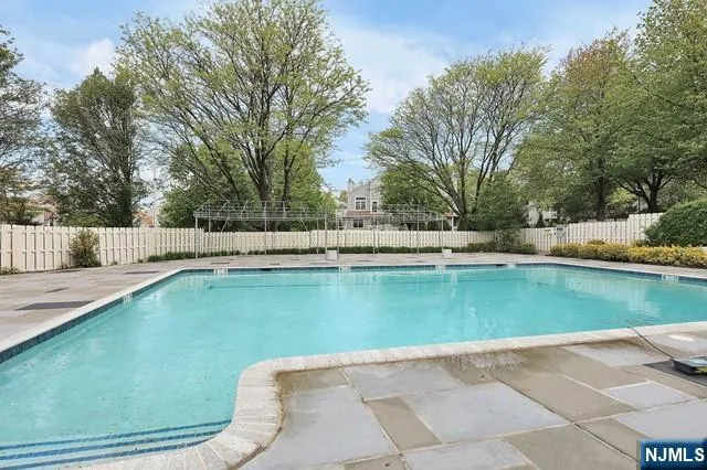 a view of a swimming pool with a yard