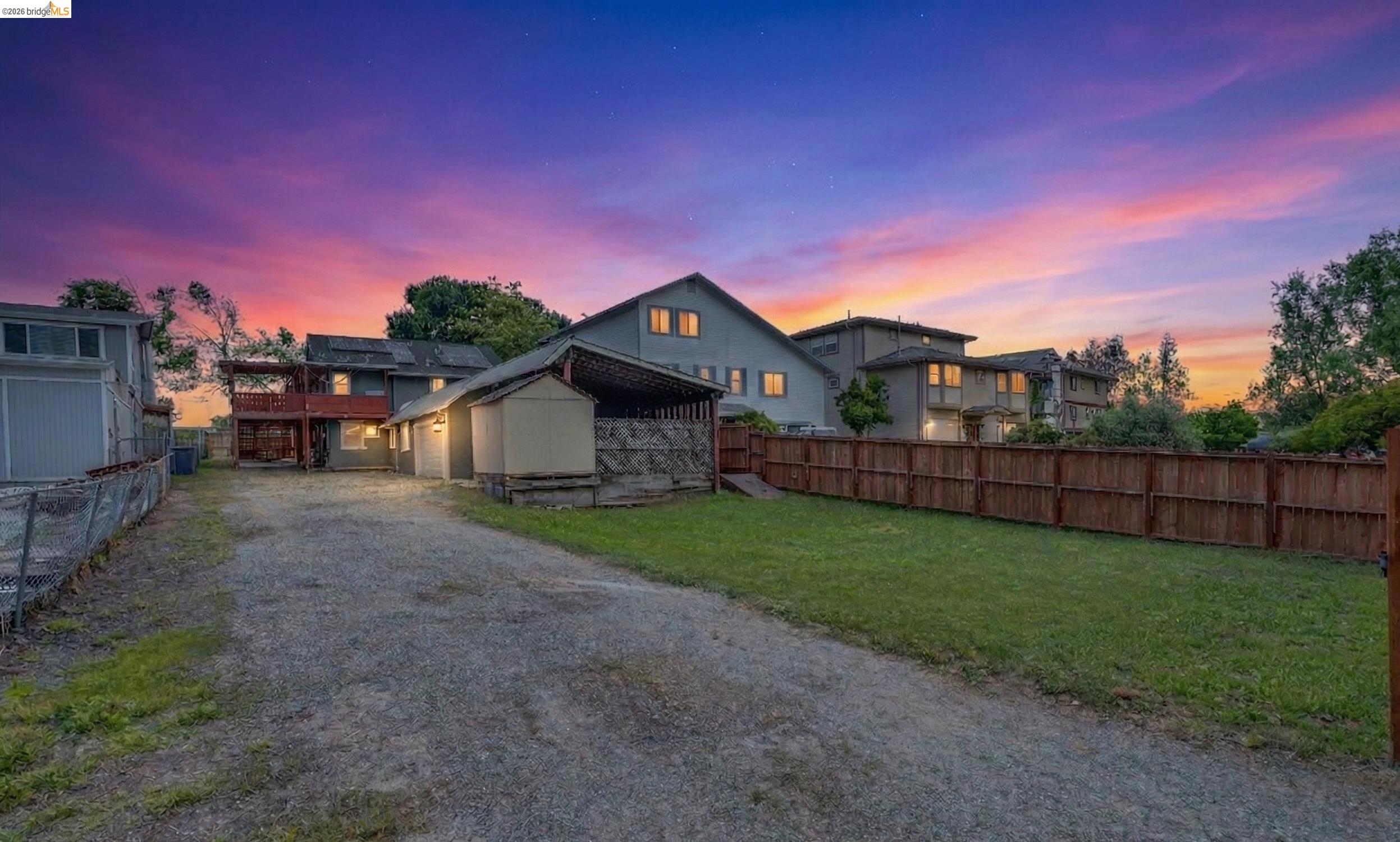 View of front of house featuring driveway and an outdoor structure