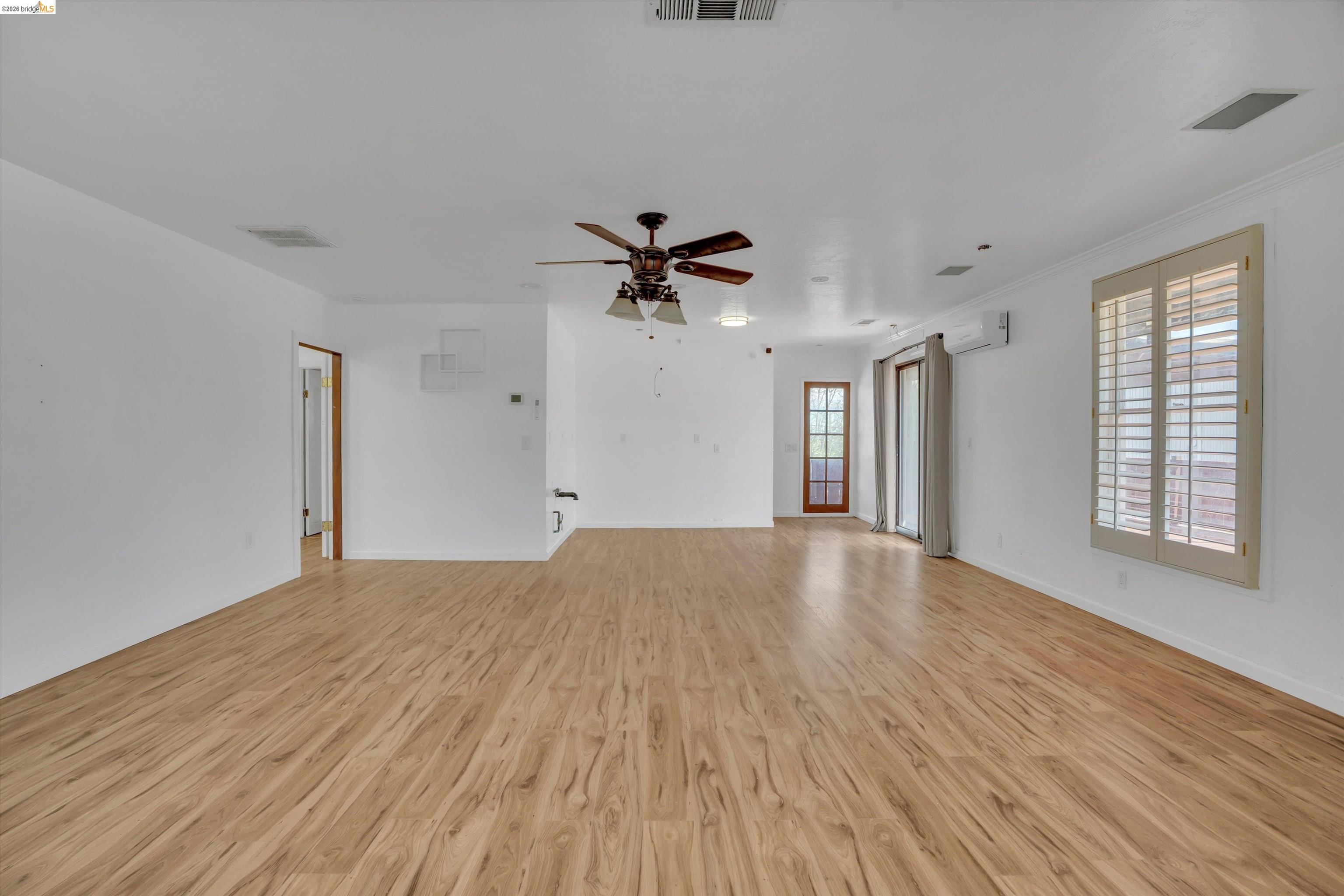 1922 Taylor Road Bethel Island, CA 94511 - Photo 14 of 49 Unfurnished living room featuring light wood finished floors, a ceiling fan, and crown molding