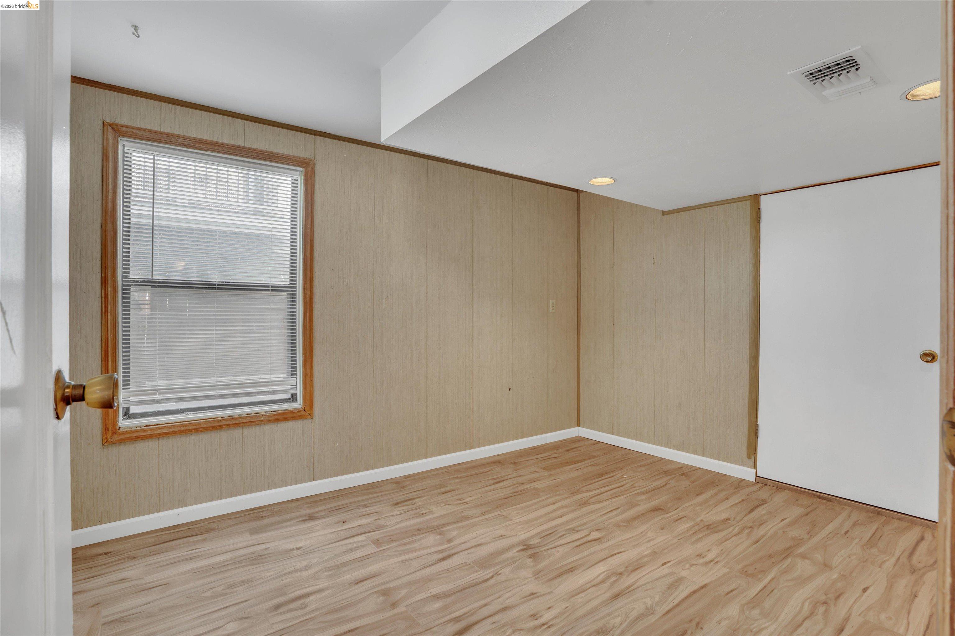 1922 Taylor Road Bethel Island, CA 94511 - Photo 17 of 49 Unfurnished room with light wood-type flooring and wood walls