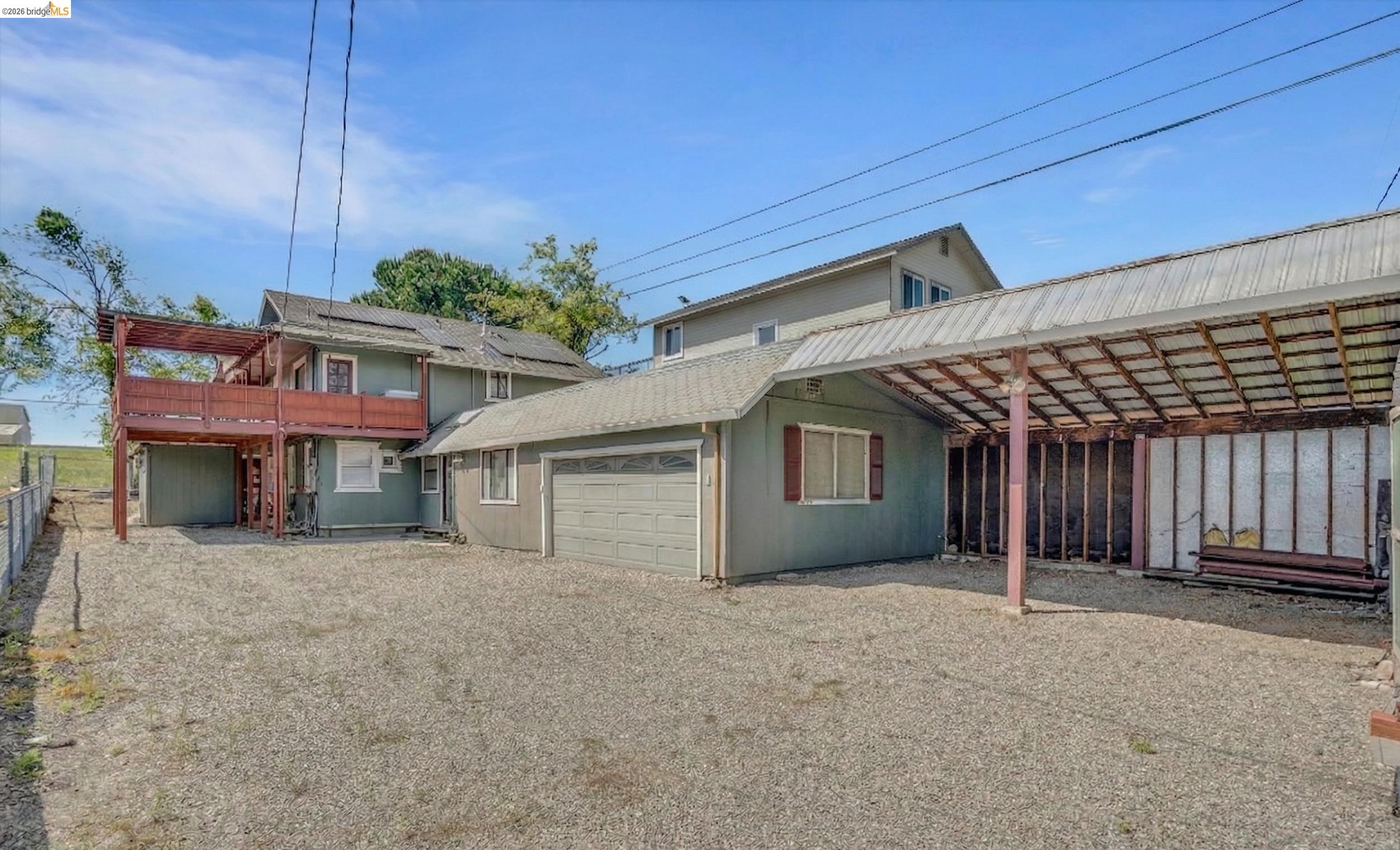 1922 Taylor Road Bethel Island, CA 94511 - Photo 2 of 49 Rear view of property featuring driveway, a shingled roof, and an attached garage