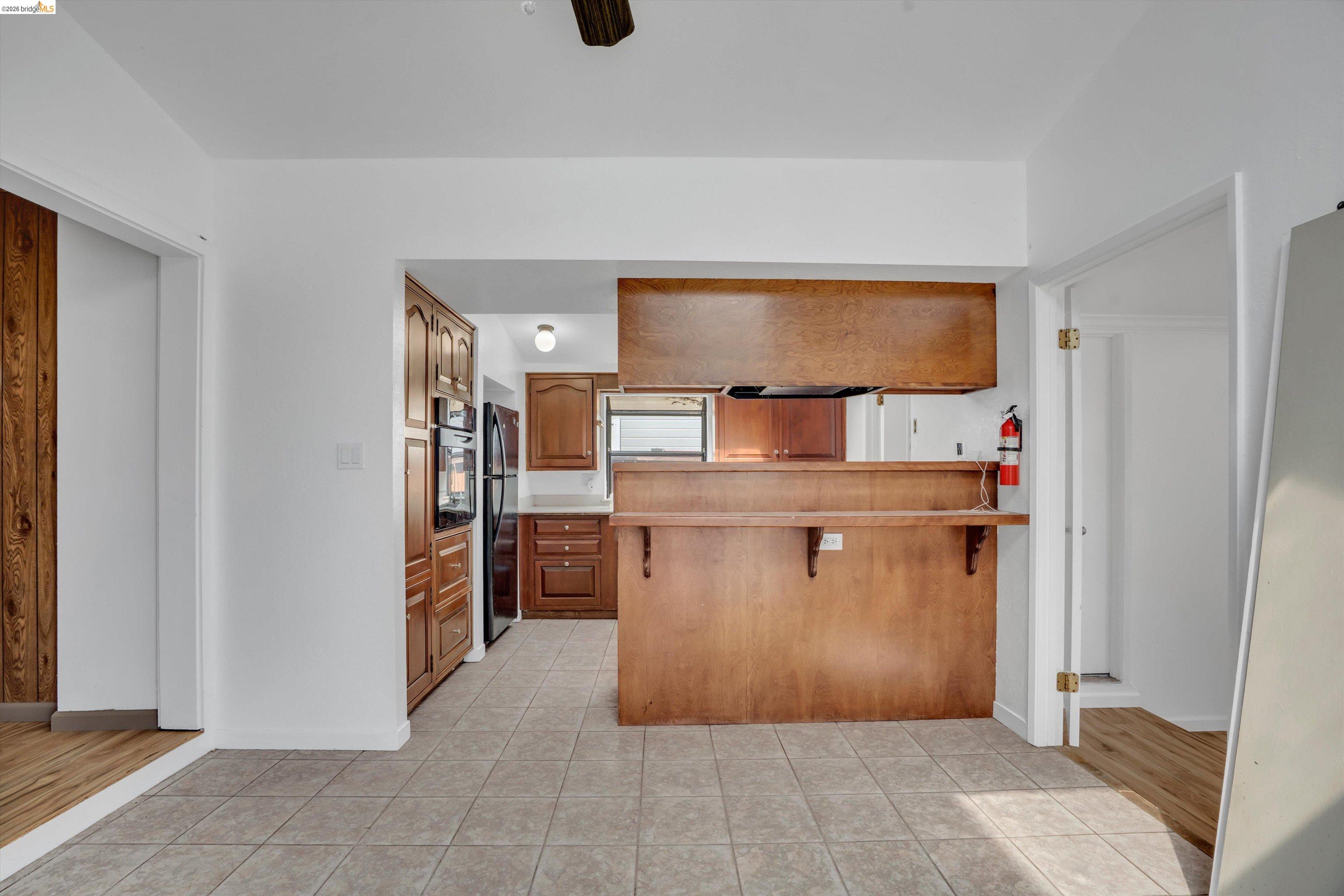1922 Taylor Road Bethel Island, CA 94511 - Photo 26 of 49 Kitchen with a peninsula, a kitchen bar, light countertops, and light tile patterned floors
