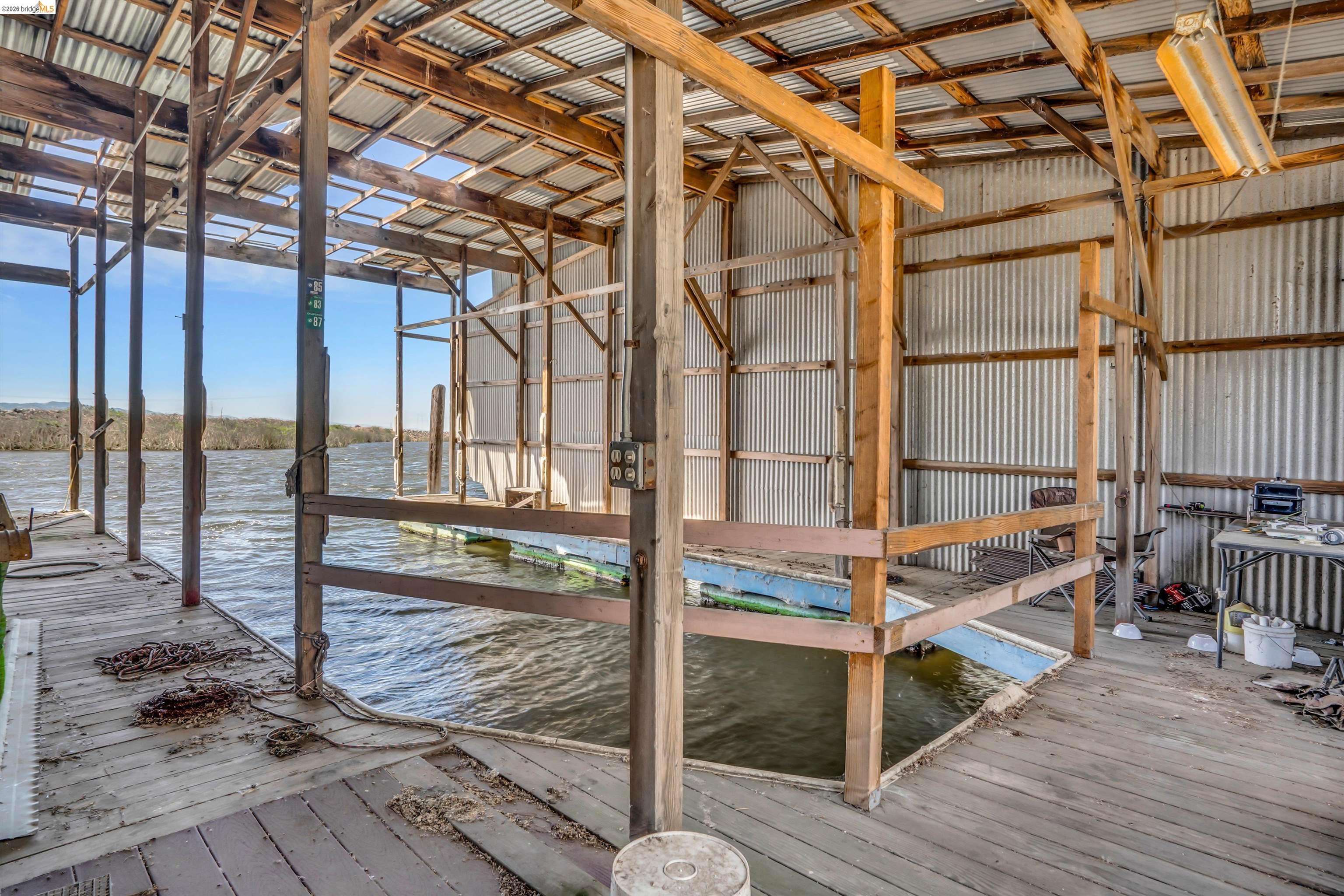 1922 Taylor Road Bethel Island, CA 94511 - Photo 38 of 49 Misc room with hardwood / wood-style flooring, a water view, and metal wall