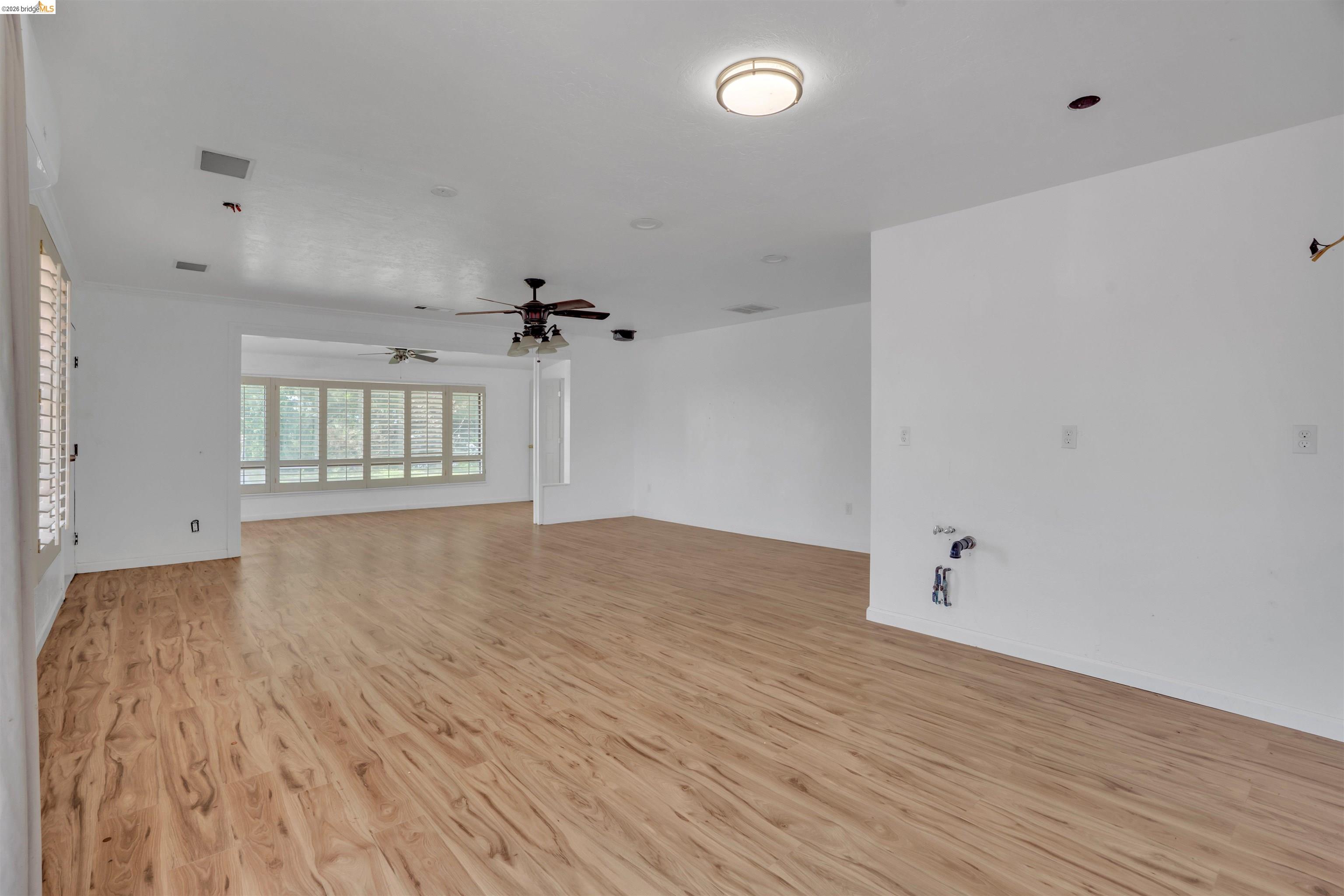 1922 Taylor Road Bethel Island, CA 94511 - Photo 8 of 49 Unfurnished living room featuring light wood-style flooring and a ceiling fan