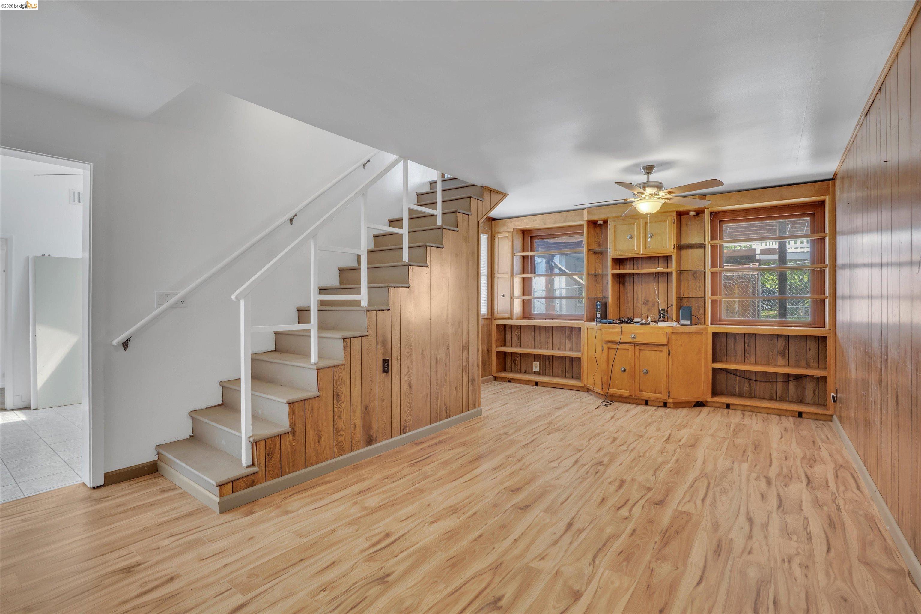 1922 Taylor Road Bethel Island, CA 94511 - Photo 10 of 49 Unfurnished living room featuring light wood-type flooring, wooden walls, and a ceiling fan