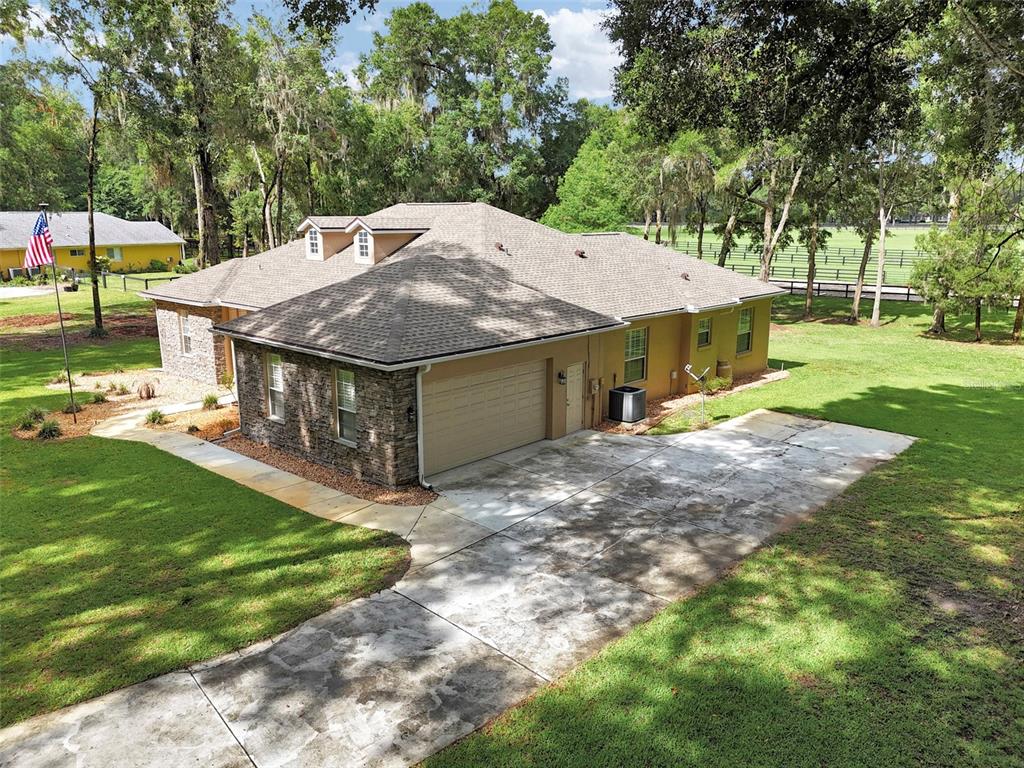 1989 Northwest 111th Loop Ocala, FL 34475 - Photo 42 of 55 a view of a house with a yard and sitting area