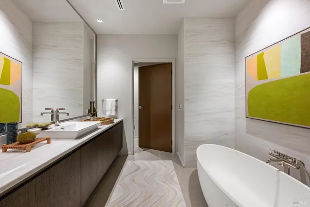 a bedroom with bed and a flat screen tv