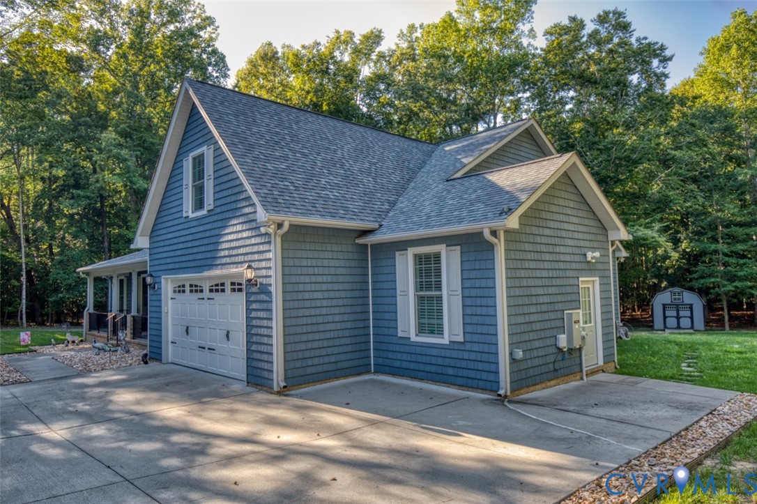 7075 Menzels Road Toano, VA 23168 - Photo 46 of 50 Blue shingle siding, white garage door, concrete d