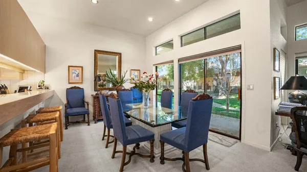a view of a dining room with furniture window and outside view