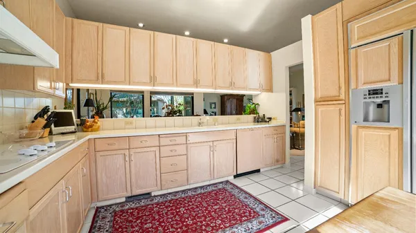 a kitchen with a white cabinets and white appliances