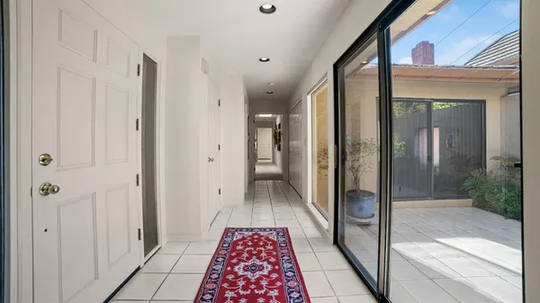 a view of hallway with a shower and a sink
