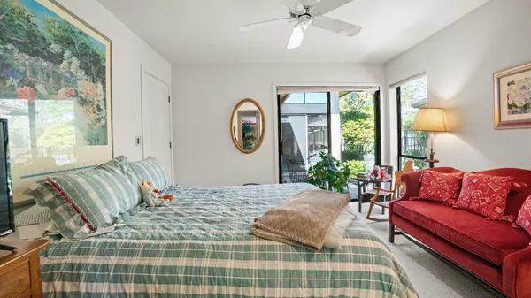 a bedroom with a bed couch and window