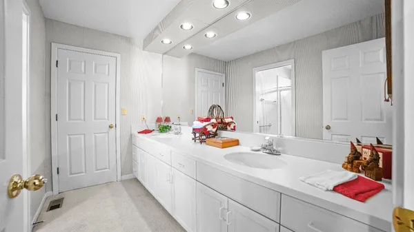 a bathroom with a sink mirror and vanity