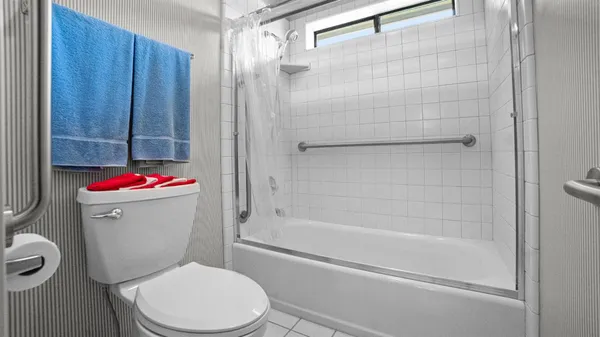 a white toilet and shower sitting next to a bathroom sink