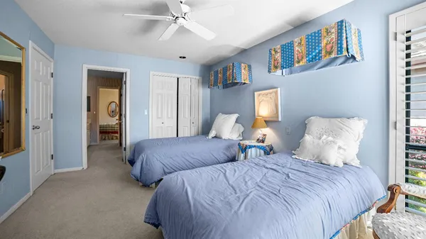 a bedroom with two beds and a chandelier