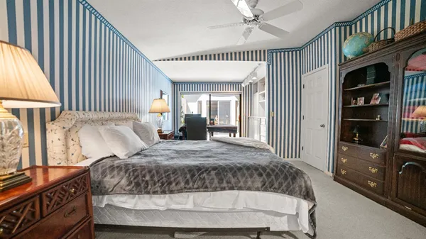 a bedroom with a bed window and a walk in closet