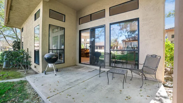 a building outdoor space with patio furniture and potted plants
