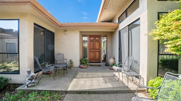 a front view of a house with outdoor seating