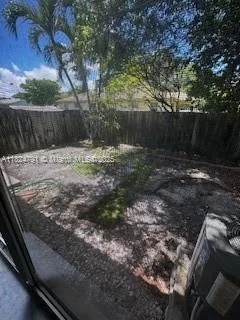 a view of a backyard with wooden fence