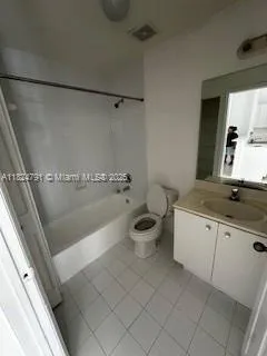 a bathroom with a granite countertop sink a toilet and a mirror