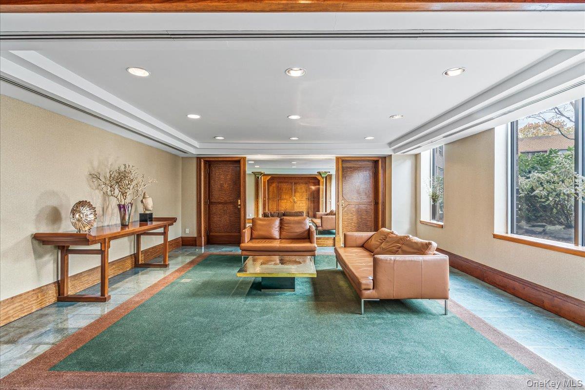 112-01 Queens Boulevard, Unit 23C Queens, NY 11375 - Photo 28 of 32 a living room with furniture and a window