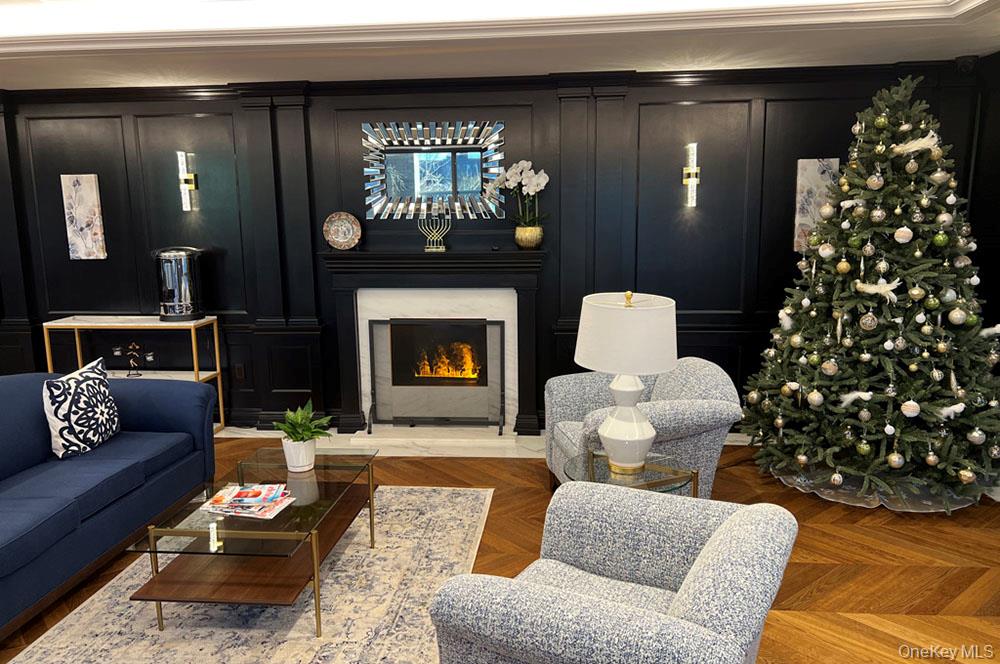 112-01 Queens Boulevard, Unit 23C Queens, NY 11375 - Photo 31 of 32 a living room with furniture and a fireplace