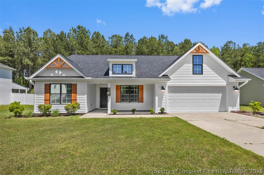 83 Kotata Avenue Bunnlevel, NC 28323 - Photo 1 of 49 a front view of a house with a yard and trees