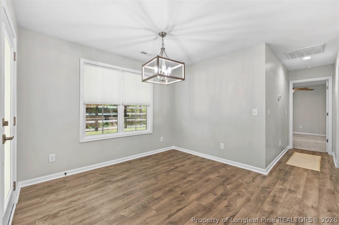 83 Kotata Avenue Bunnlevel, NC 28323 - Photo 23 of 49 wooden floor in an empty room with a window