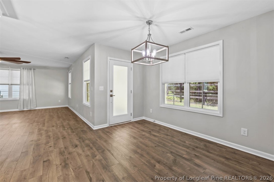 83 Kotata Avenue Bunnlevel, NC 28323 - Photo 25 of 49 a view of an empty room with wooden floor fridge and a window