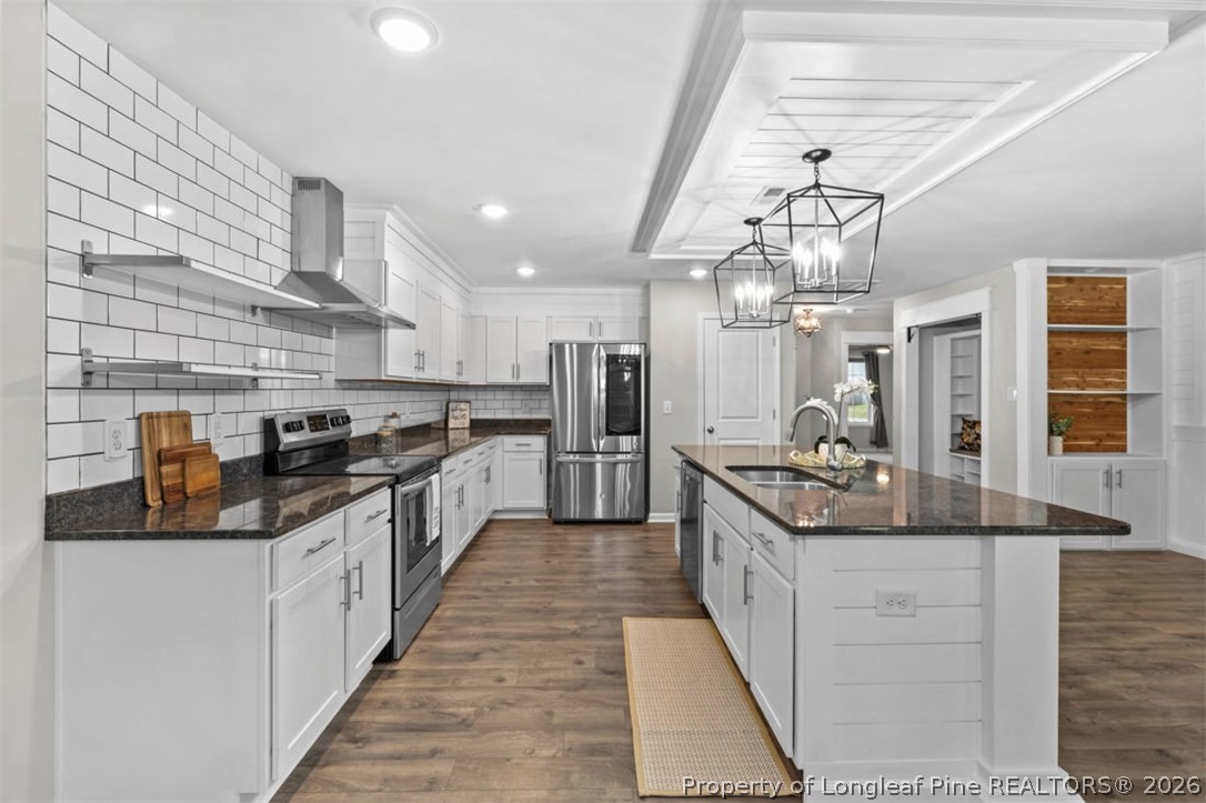 83 Kotata Avenue Bunnlevel, NC 28323 - Photo 26 of 49 a large kitchen with stainless steel appliances kitchen island granite countertop a large counter top a stove and a refrigerator