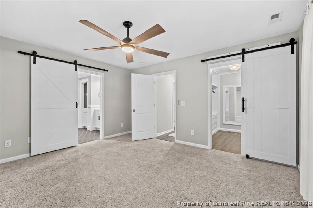 83 Kotata Avenue Bunnlevel, NC 28323 - Photo 35 of 49 a view of empty room with wooden floor and ceiling fan